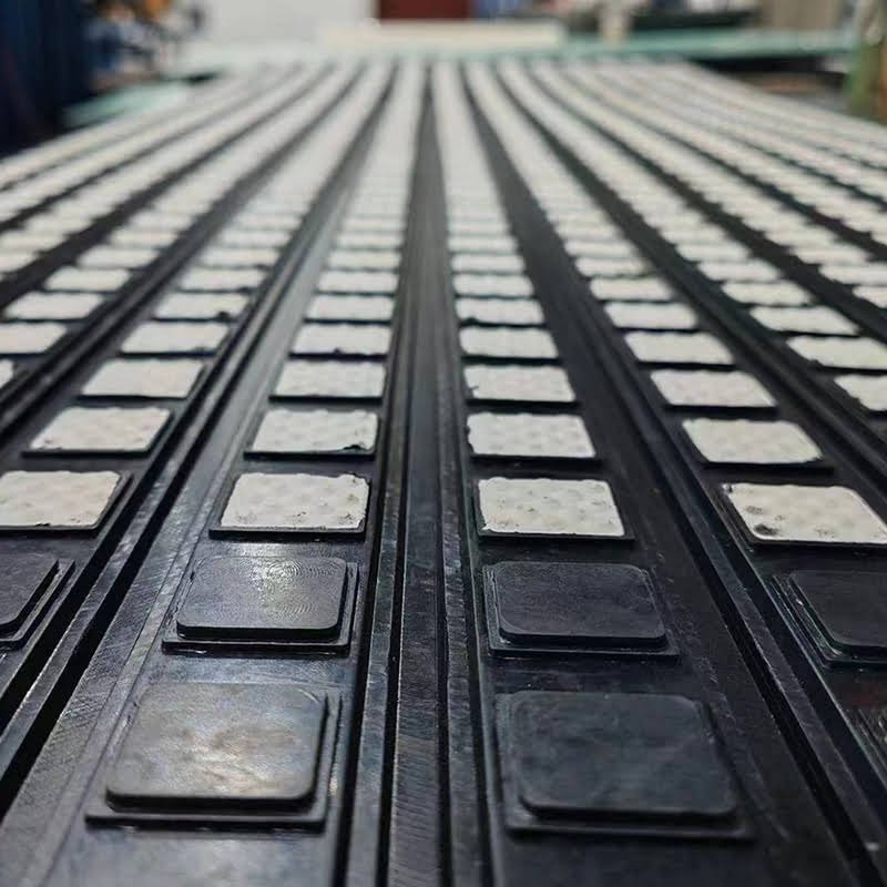 Close-up of dimple ceramic tiles on HUAYE-CRL-15 pulley lagging